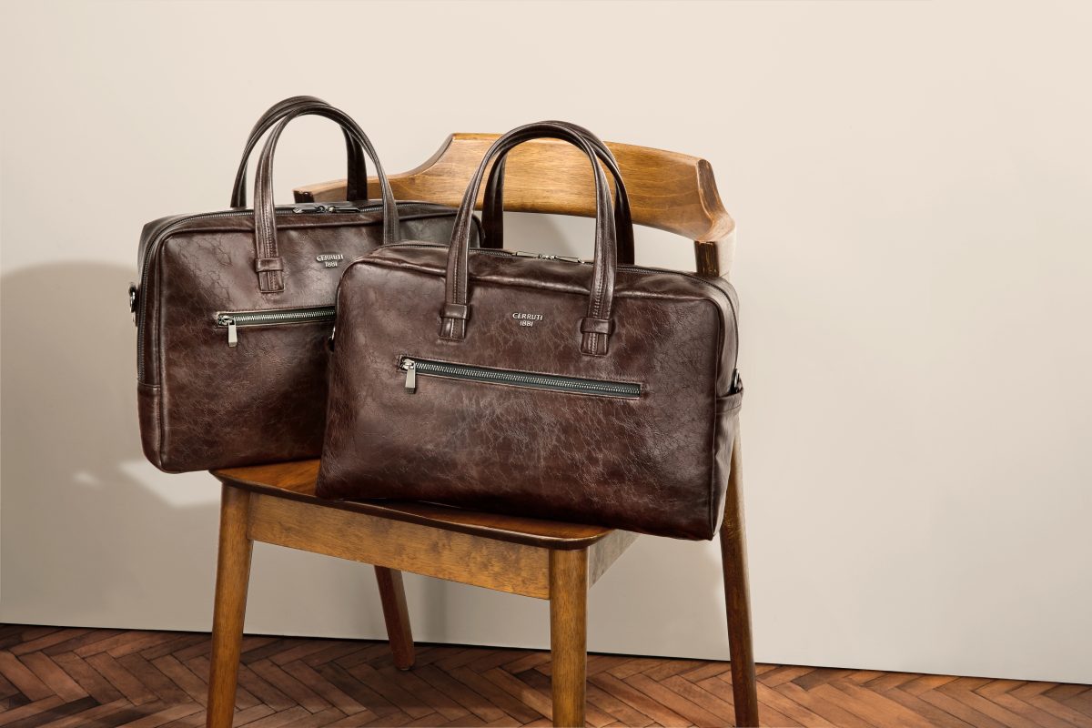 Two briefcases in brown grained leather on a wooden chair — Cerruti 1881